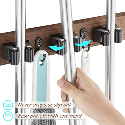 Close view of long-handled tools secured in the wall holder