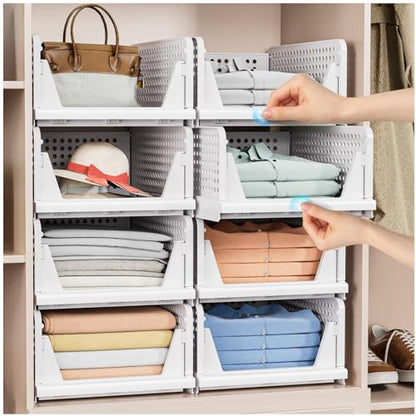 White foldable storage baskets organizing folded clothes